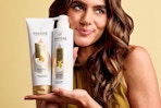 Woman holding Pantene Pro-V Miracles products