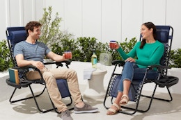 a couple sitting on zero gravity chairs