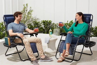 a couple sitting on zero gravity chairs