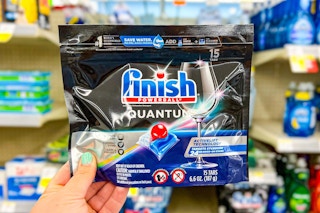 hand holding a pack of finish quantum dishwasher detergent