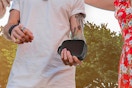 man holding portable speaker outside