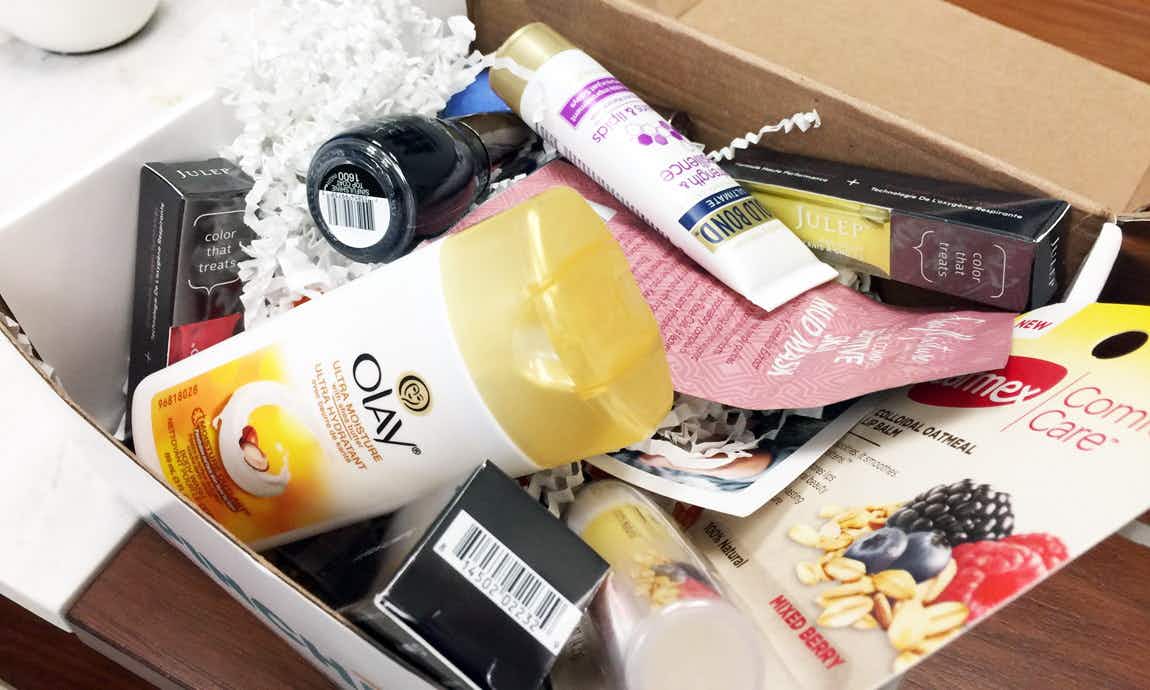 A box filled with samples of beauty products from brands like Olay and Gold Bond.