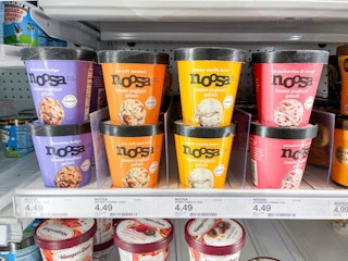 Several pints of Noosa Frozen Yoghurt Gelato sitting in a shelf in a freezer.