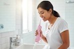 a woman using a water flosser