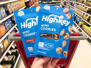hand holding two bags of highkey cookies at target