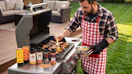 a person grilling on a grill outside
