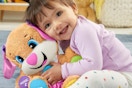 a girl playing with a plush