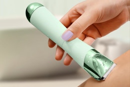 a woman using a bikini trimmer