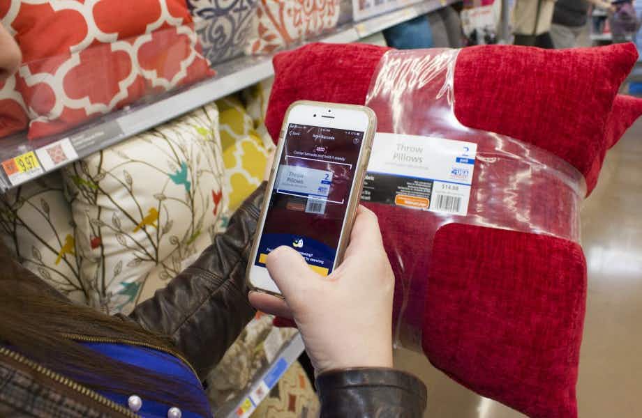 A person scanning a throw pillow with the Walmart app.