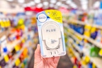 person holding a febreze plug oil warmer in an aisle