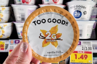 hand holding a cup of dannon two good yogurt at kroger