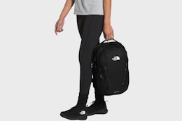 a woman carrying the north face backpack