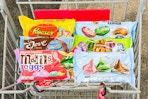 reeses, hersheys, dove, rolo, and m&ms candy in a cart