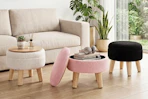 Lifestyle image of three Gianna Round Ottomans in white, pink and black in a home setting
