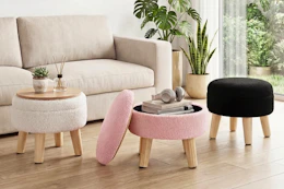 Lifestyle image of three Gianna Round Ottomans in white, pink and black in a home setting