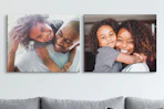 canvas prints on a wall behind a couch