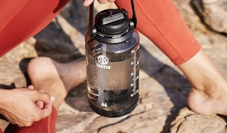 person holding takeya water bottle