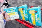 hand holding pampers diaper packs in cvs