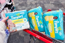 hand holding pampers diaper packs in cvs