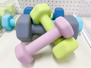 dumbbells payed across each other on a shelf in target