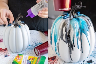someone putting crayons on a faux pumpkin and melting them with a hair dryer