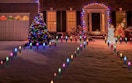 the front yard with colorful Christmas lights on the ground