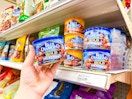 hand holdingblue diamond almonds in front of a target shelf