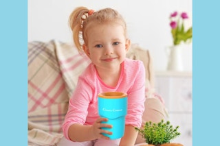 child holding a slushy cup