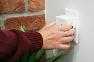 kasa smart plug being plugged into outlet