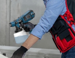 a person using a paint sprayer