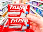 hand holding 2 boxes of tylenol at target