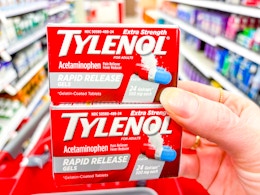 hand holding 2 boxes of tylenol at target