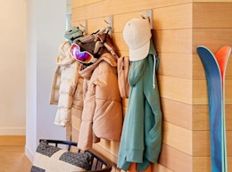 coats and hats on hooks on a wall