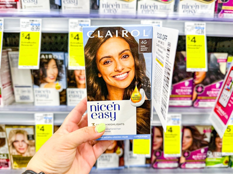 person holding clairol nice n easy hair color in front of the shelf
