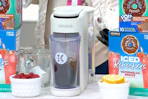 a Keurig coffee maker set next to bowls of fruit