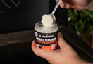 hand holding a container of Blackstone Griddles Seasoning