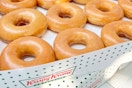 stacked boxes of krispy kreme original glazed doughnuts