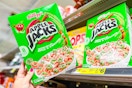 hand holding a box of kellogg's apple jacks cereal at dollar general