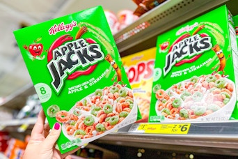 hand holding a box of kellogg's apple jacks cereal at dollar general