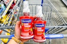 hand holding chloraseptic over walmart cart
