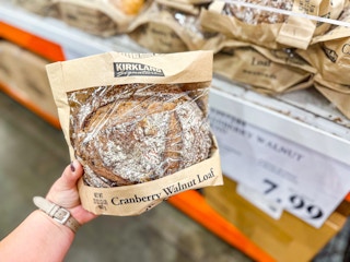 hand holding a pack of cranberry walnut bread