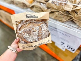 hand holding a pack of cranberry walnut bread