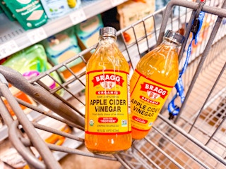 2 Bragg Apple Cider Vinegars in a Walmart shopping cart