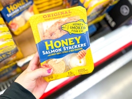 hand holding a pack of honey smoked salmon stackers