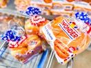 Three 8-count packs Wonder Bread buns in Walmart shopping cart