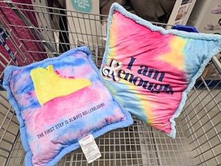 2 large barbie pillows in a cart