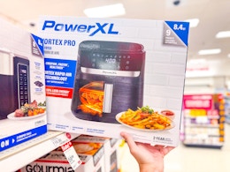 hand grabbing a powerxl air fryer off a target shelf