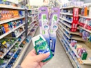 hand holding crest and oral-b items in walgreens