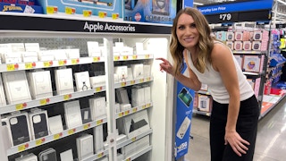 a woman looking at apple products in walmart
