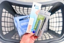 hand holding neutrogena makeup products over a Walgreens shopping basket